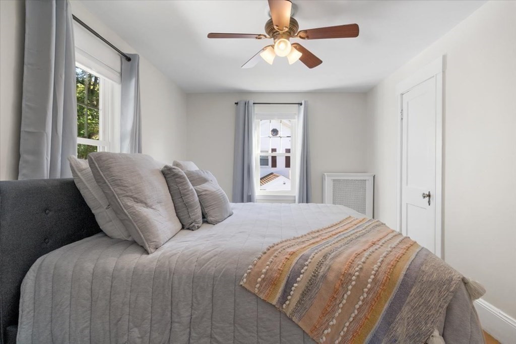 35 Clinton Road Weymouth, MA 02189 - Photo 22 of 37 a bedroom with a large bed and a chandelier