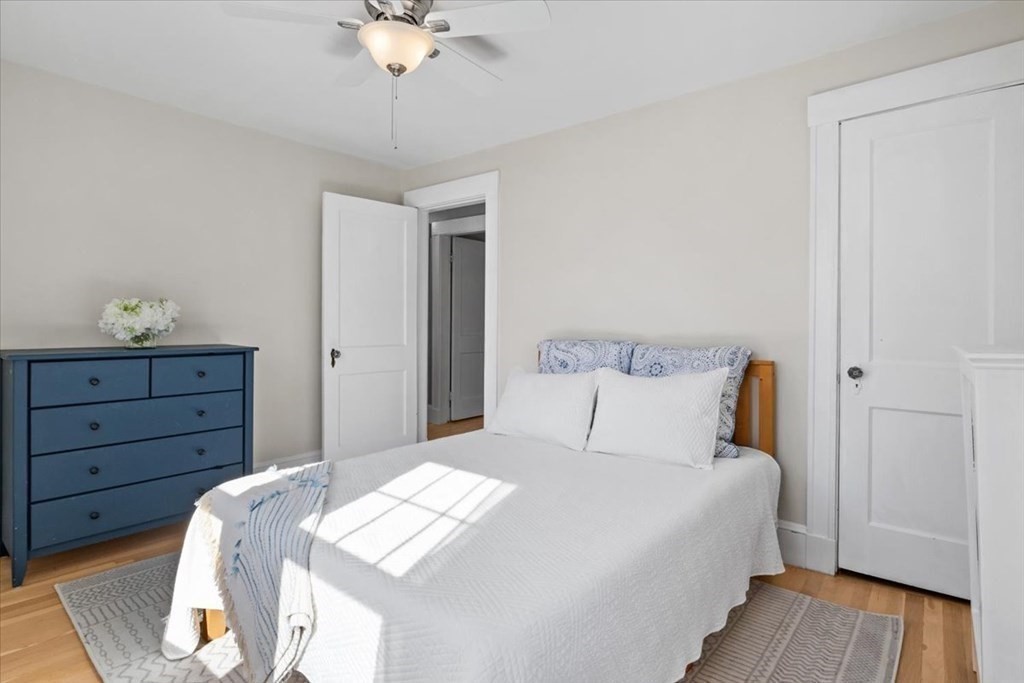 35 Clinton Road Weymouth, MA 02189 - Photo 23 of 37 a bedroom with a bed and a chandelier