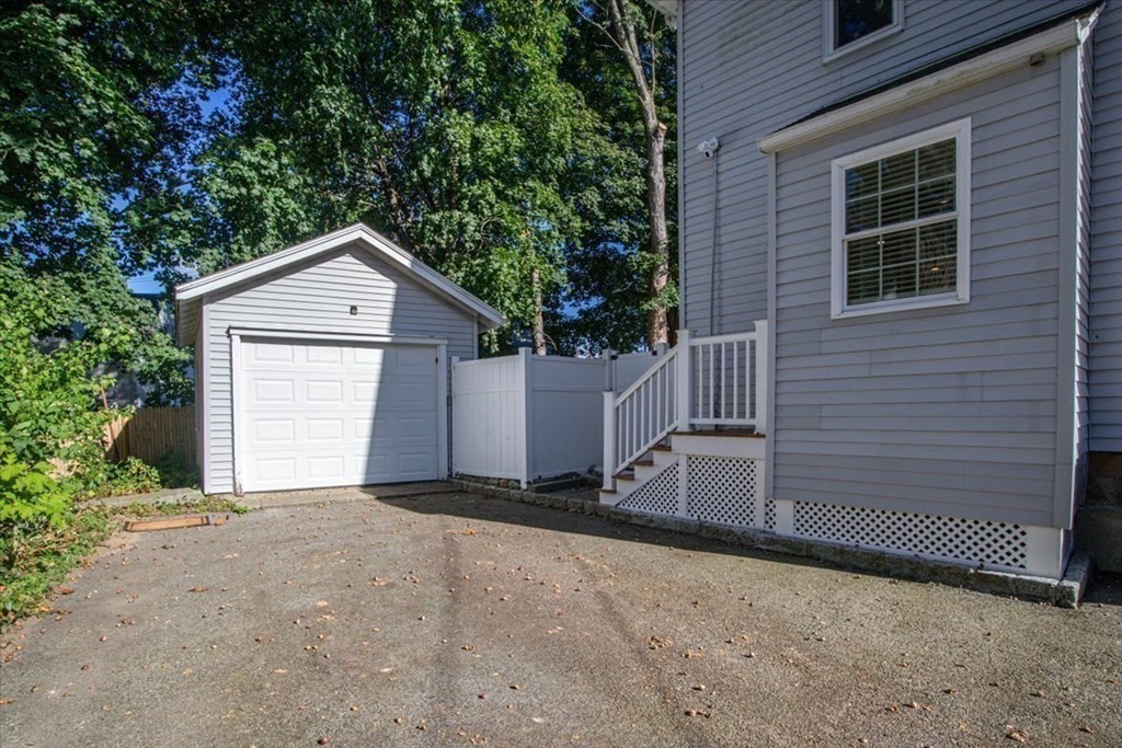 35 Clinton Road Weymouth, MA 02189 - Photo 33 of 37 a front view of a house with a yard and garage