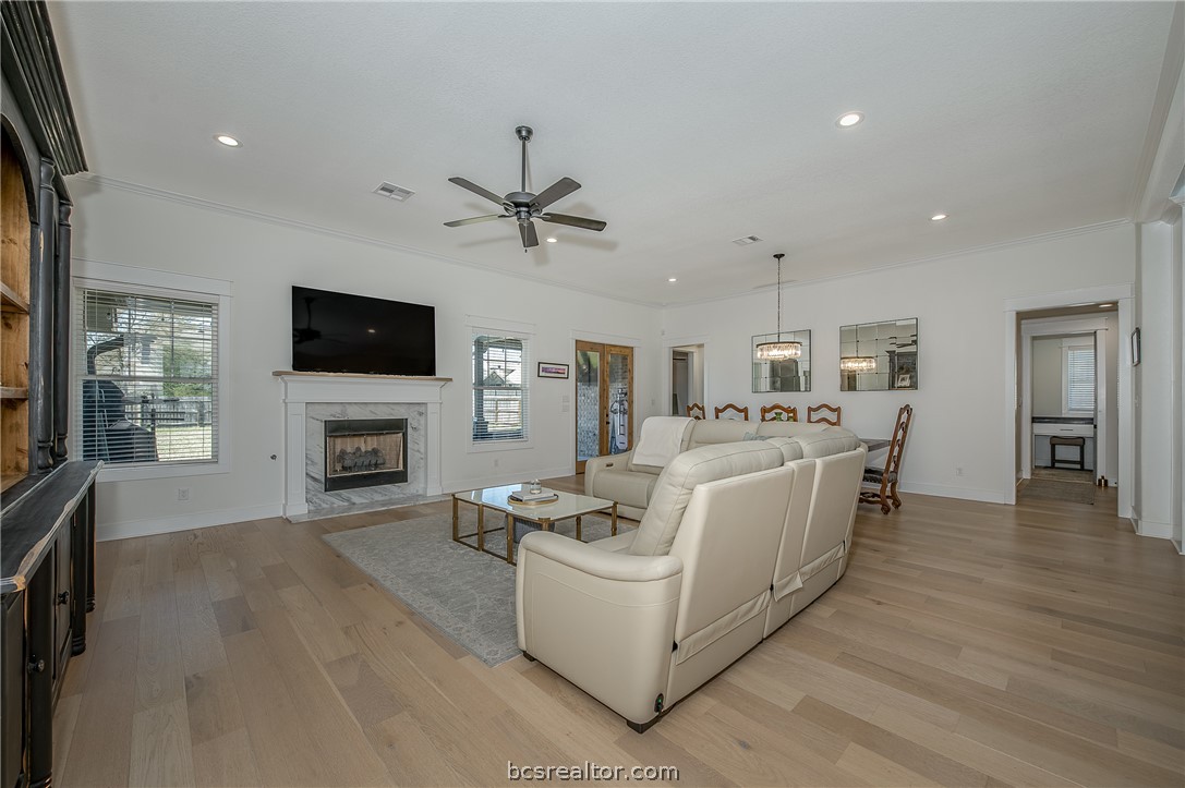 3317 Stone Leigh Lane Bryan, TX 77808 - Photo 6 of 30 a living room with furniture a fireplace and a flat screen tv