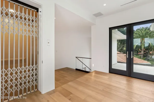 a bedroom with a large bed and a flat screen tv