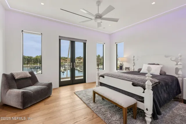 a dining room with furniture and a floor to ceiling window