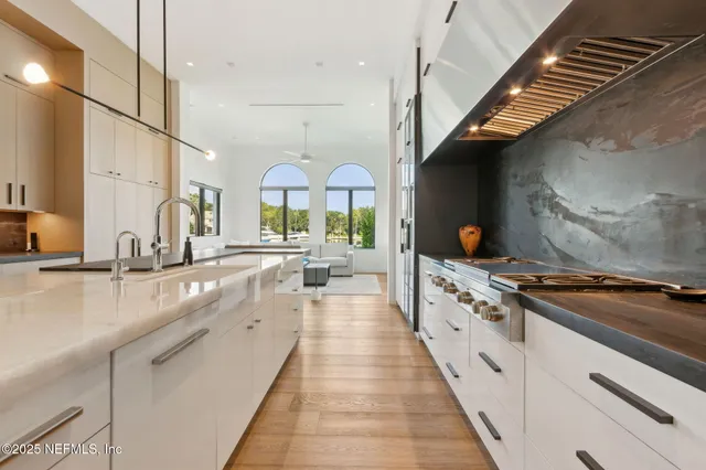 a kitchen with stainless steel appliances a stove a sink and a refrigerator