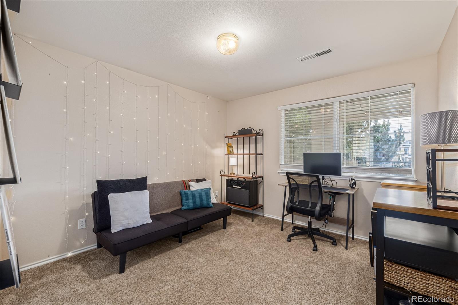 3976 Riviera Grove, Unit 203 Colorado Springs, CO 80922 - Photo 13 of 22 a view of a livingroom with workspace and a window