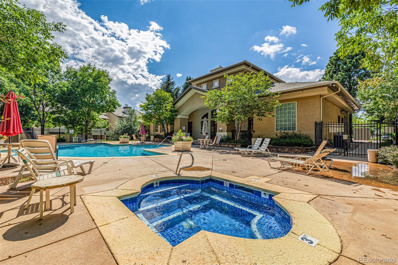 3976 Riviera Grove, Unit 203 Colorado Springs, CO 80922 - Photo 16 of 22 a swimming pool with barbeque oven outdoor seating