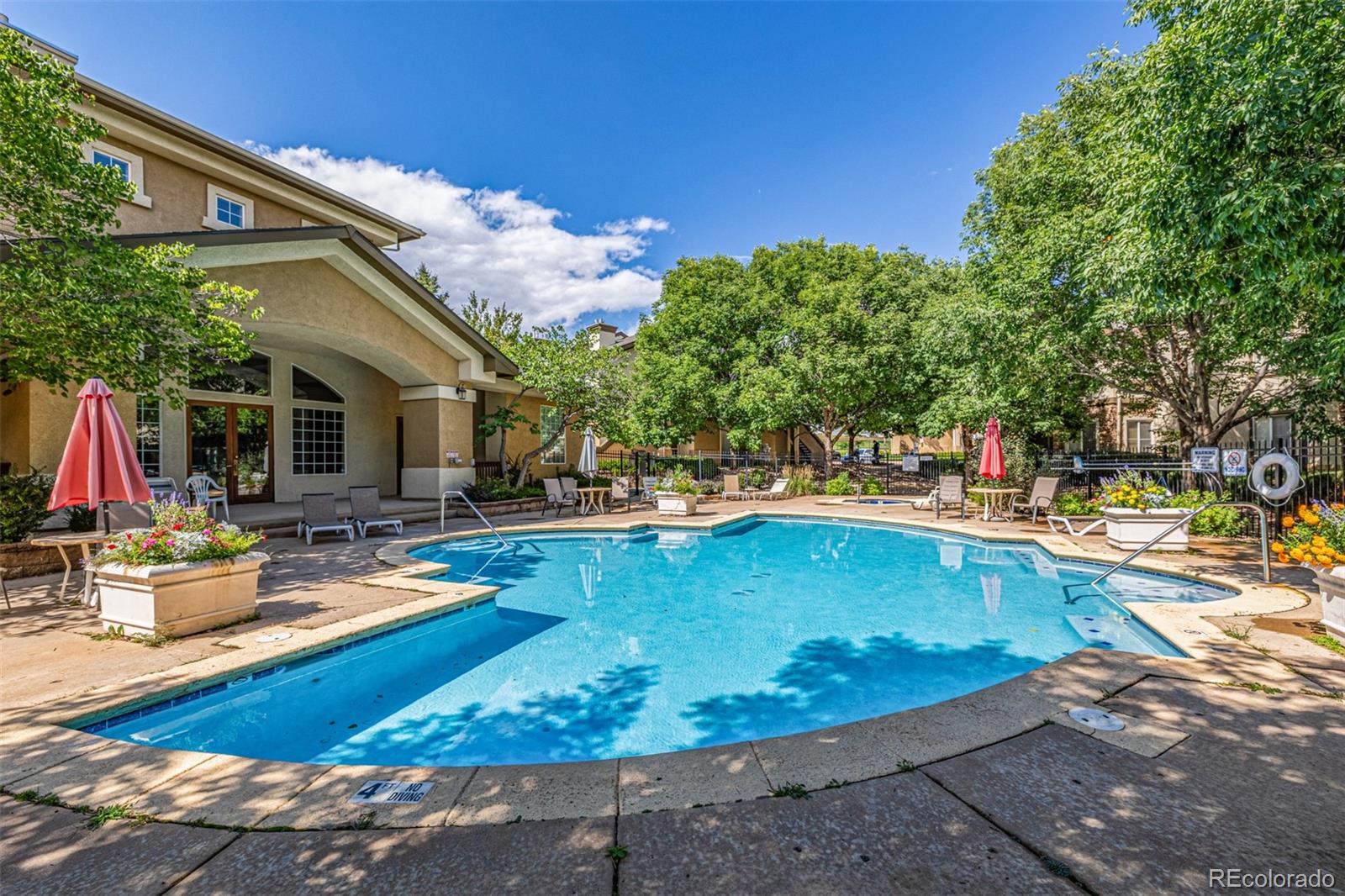 3976 Riviera Grove, Unit 203 Colorado Springs, CO 80922 - Photo 17 of 22 a view of a swimming pool with chairs