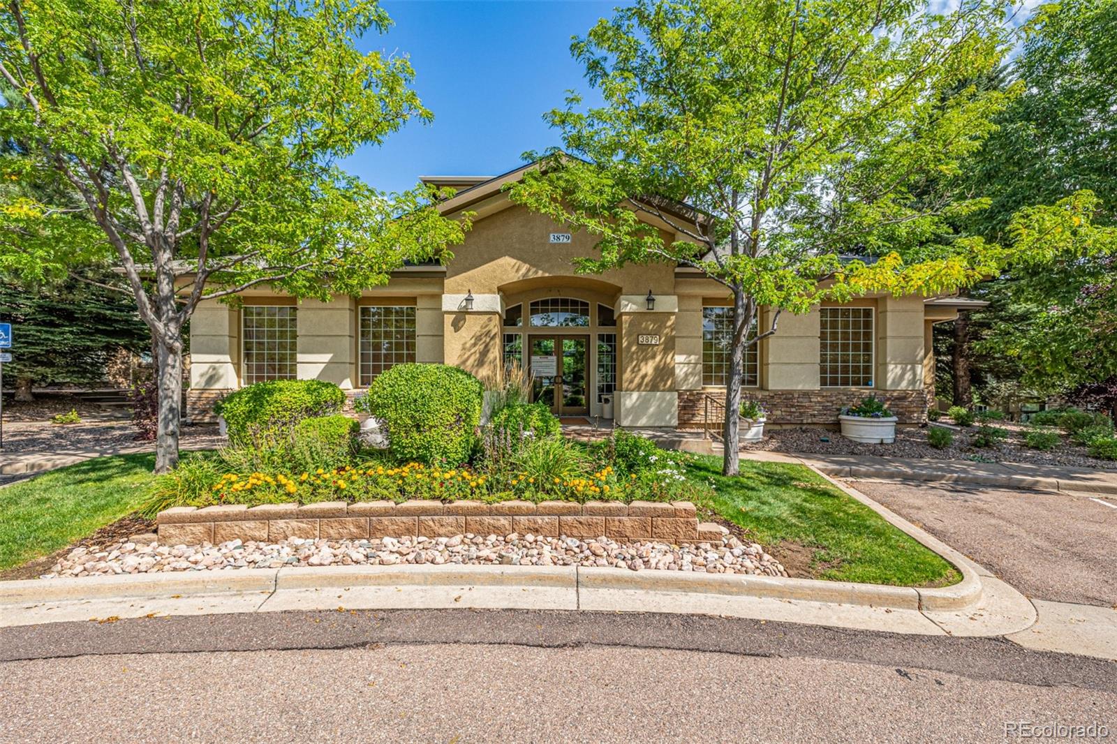 3976 Riviera Grove, Unit 203 Colorado Springs, CO 80922 - Photo 18 of 22 front view of a house with a small yard