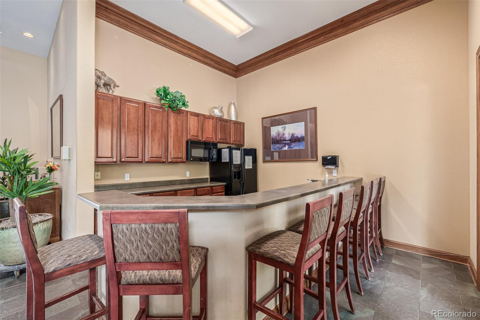 3976 Riviera Grove, Unit 203 Colorado Springs, CO 80922 - Photo 20 of 22 a kitchen with a table and chairs in it