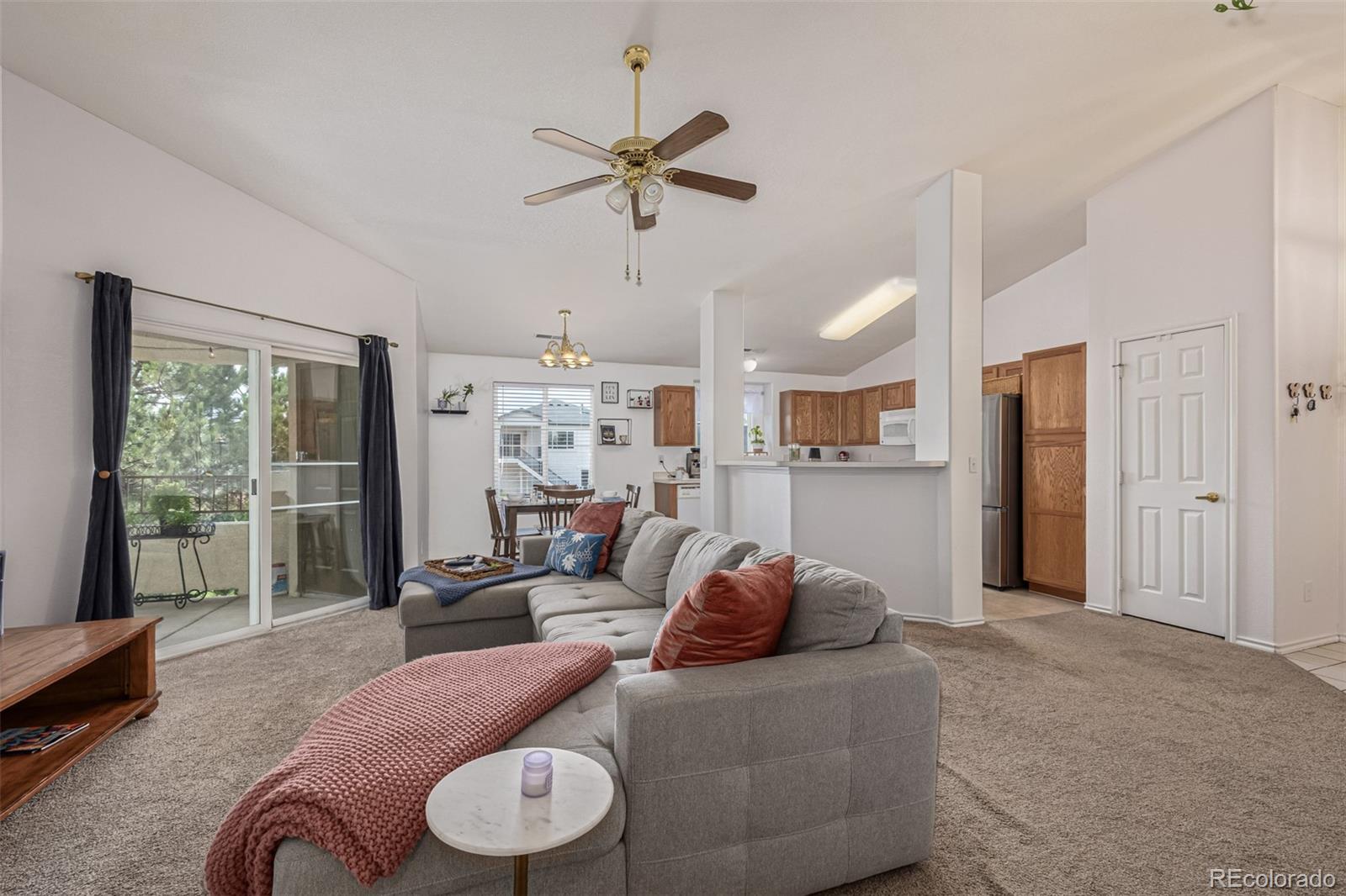 3976 Riviera Grove, Unit 203 Colorado Springs, CO 80922 - Photo 4 of 22 a living room with furniture and a large window