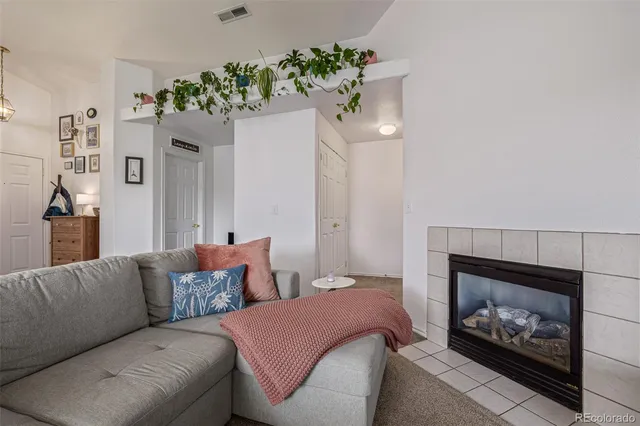 a living room with furniture a fireplace and a fireplace