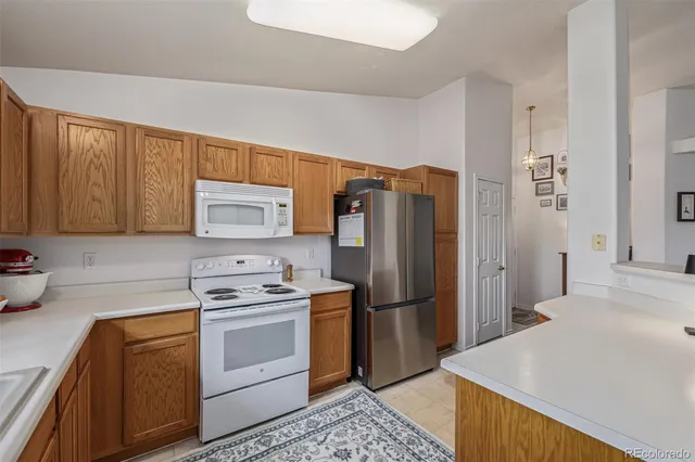a kitchen with a refrigerator sink stove and cabinets