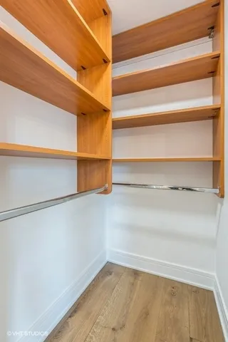 a view of walk in closet with empty racks