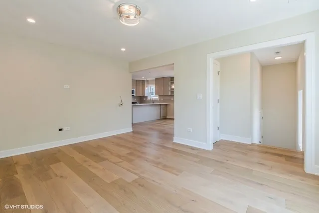 a view of a kitchen with a sink and a refrigerator