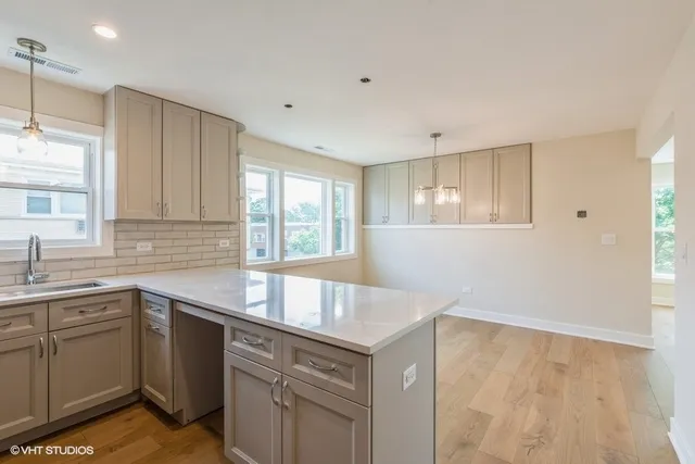 a kitchen with a sink stove and cabinets