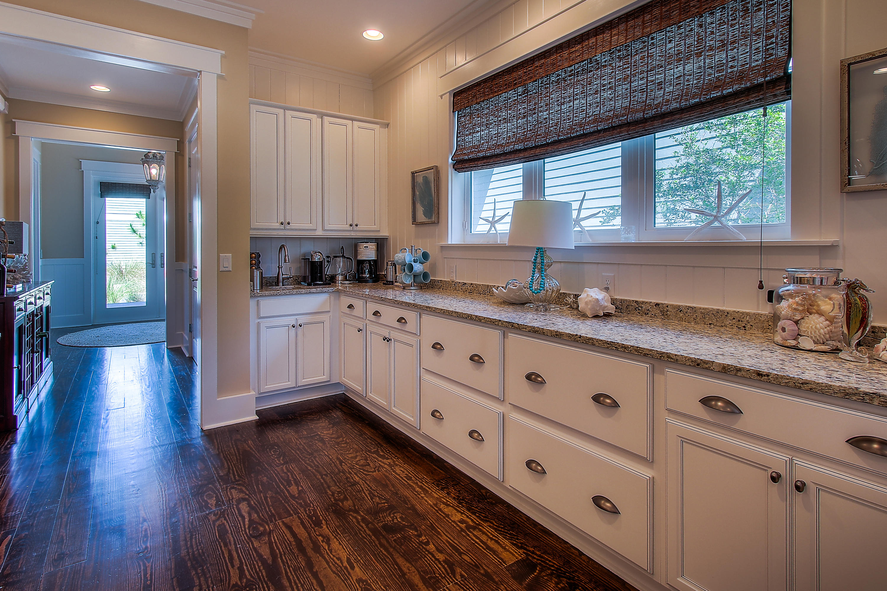 65 Flatwoods Forest Loop Santa Rosa Beach, FL 32459 - Photo 12 of 51 a kitchen with granite countertop a sink cabinets wooden floor and a window
