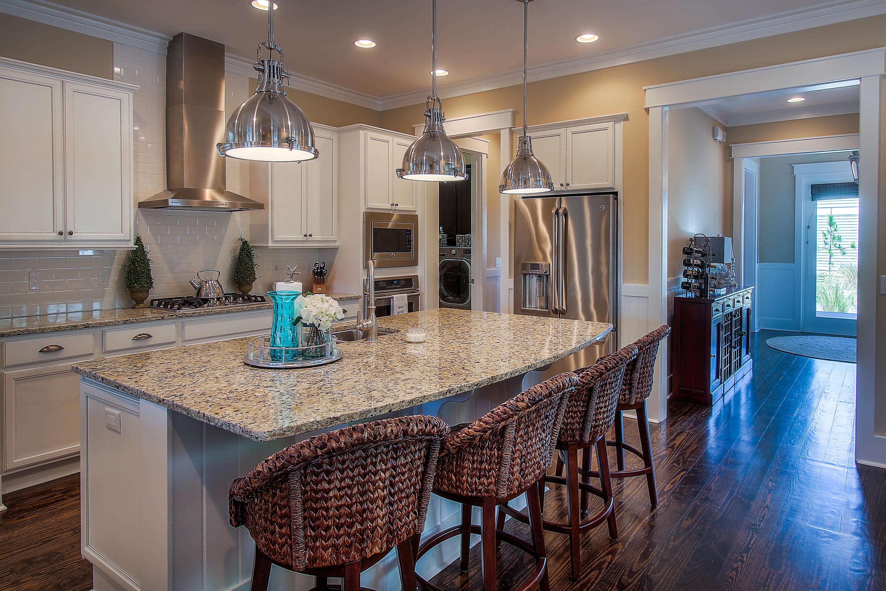 65 Flatwoods Forest Loop Santa Rosa Beach, FL 32459 - Photo 9 of 51 a kitchen with stainless steel appliances granite countertop a kitchen island a stove a sink a dining table and chairs