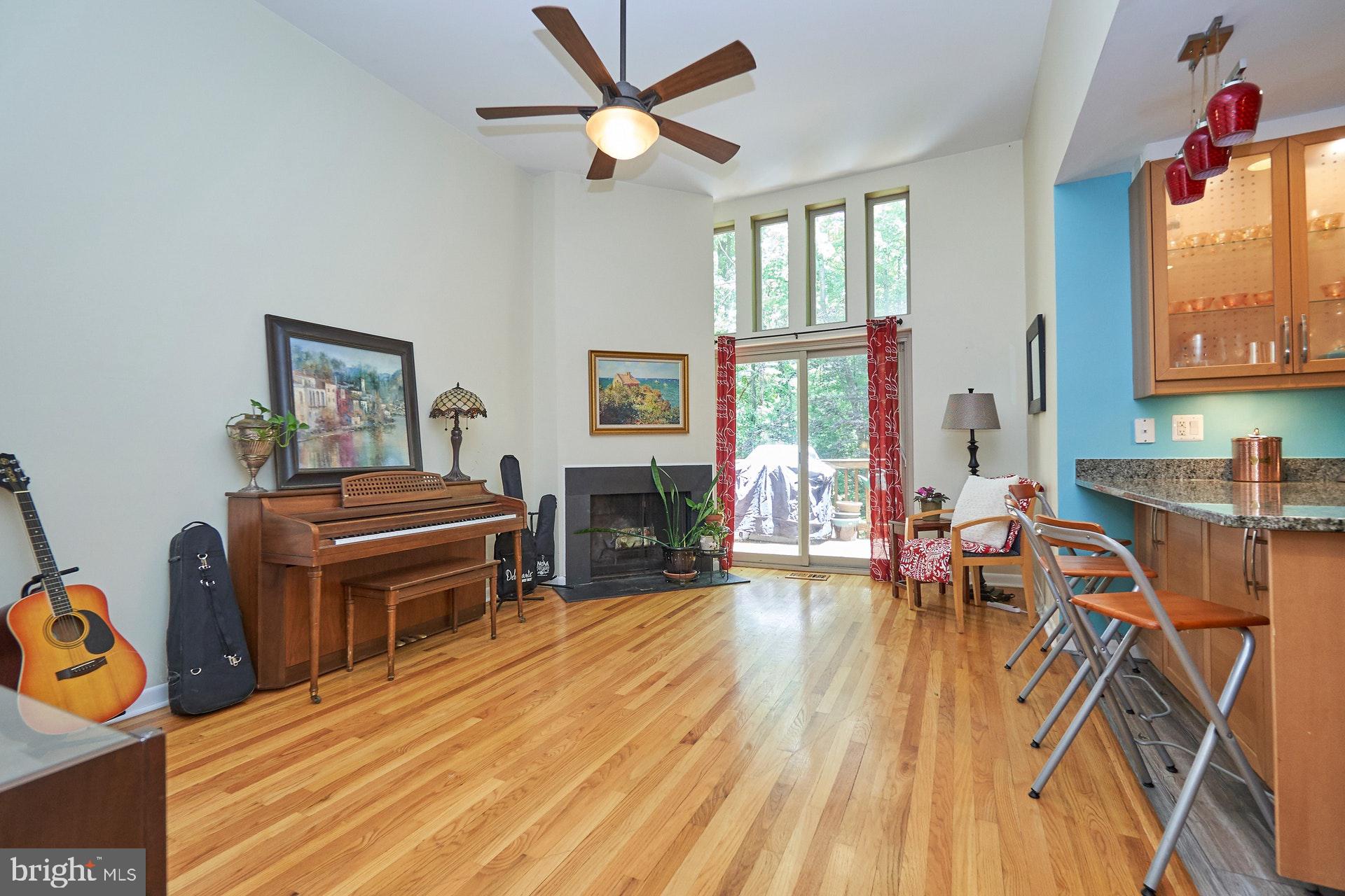 1509 Inlet Court Reston, VA 20190 - Photo 3 of 29 Living room with fireplace facing deck and trees
