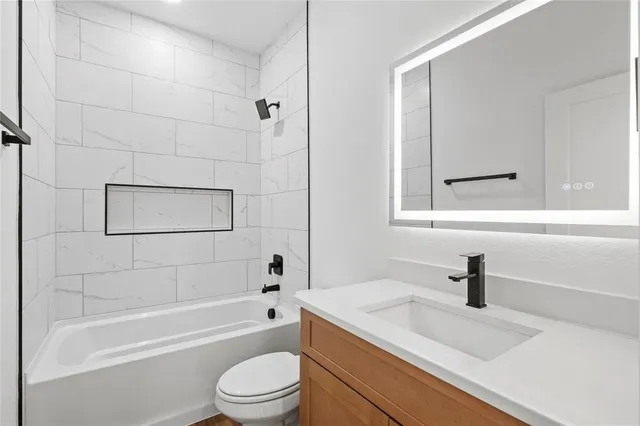 a bathroom with a sink a toilet and a bathtub