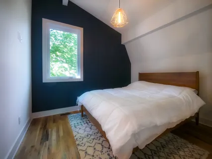 a bedroom with a bed and a window