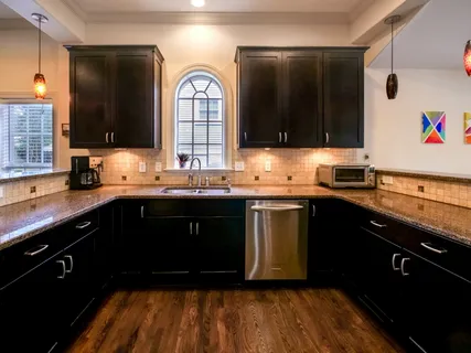 a kitchen with granite countertop stainless steel appliances and sink