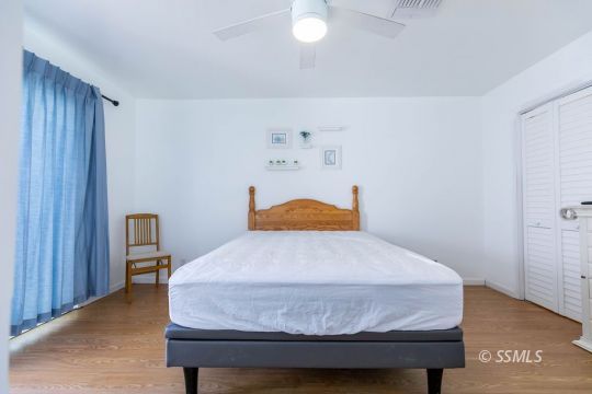 1016 Peg Street Ridgecrest, CA 93555 - Photo 16 of 26 a bedroom with a bed and dresser