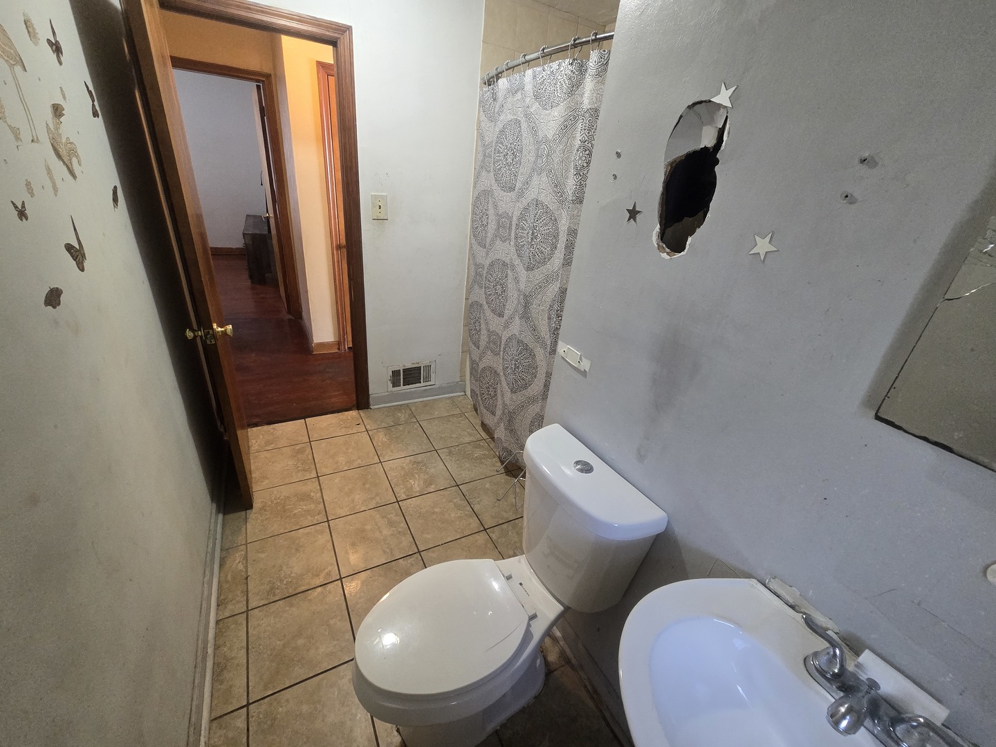566 Hirsch Avenue Calumet City, IL 60409 - Photo 14 of 29 a white toilet sitting next to a bathroom sink and a shower