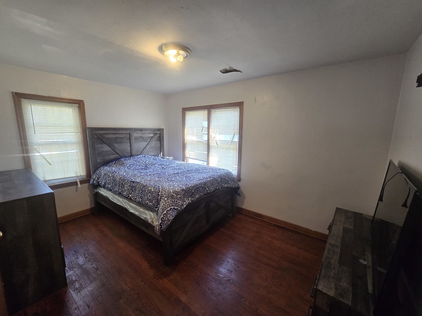 566 Hirsch Avenue Calumet City, IL 60409 - Photo 15 of 29 a bedroom with a bed and wooden floor
