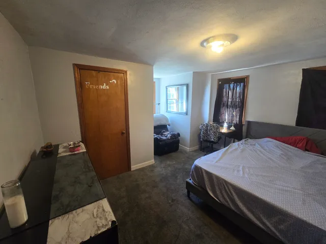 a bedroom with a bed and window