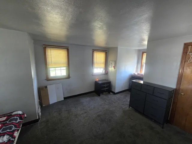 an empty room with windows and closet