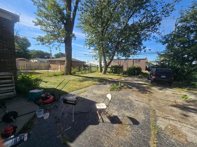 a view of a backyard with large trees