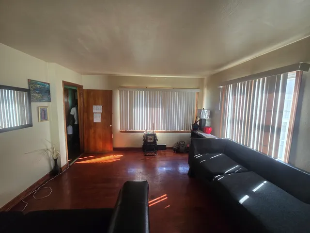 a living room with furniture window and wooden floor