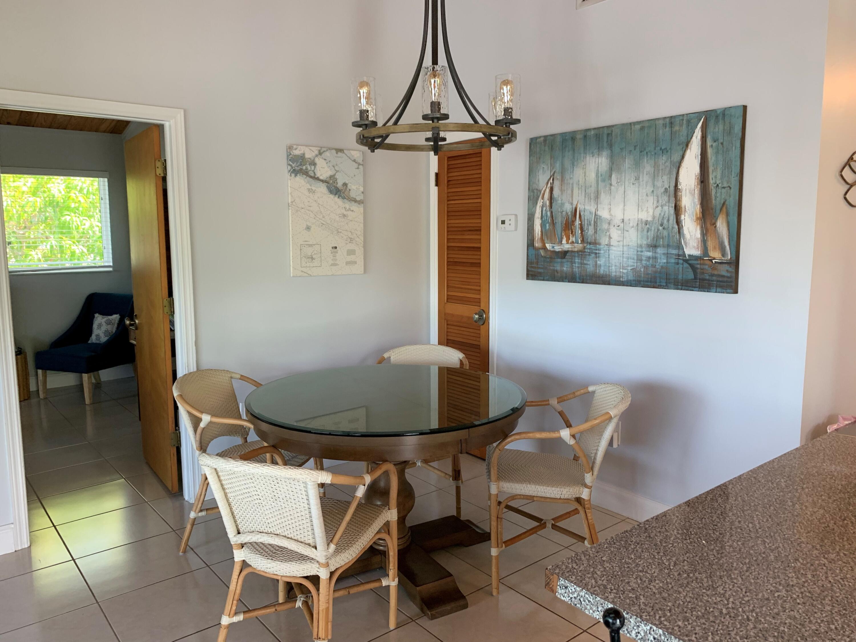 112 Captains Court Tavernier, FL 33070 - Photo 12 of 41 a view of a dining room with furniture and chandelier