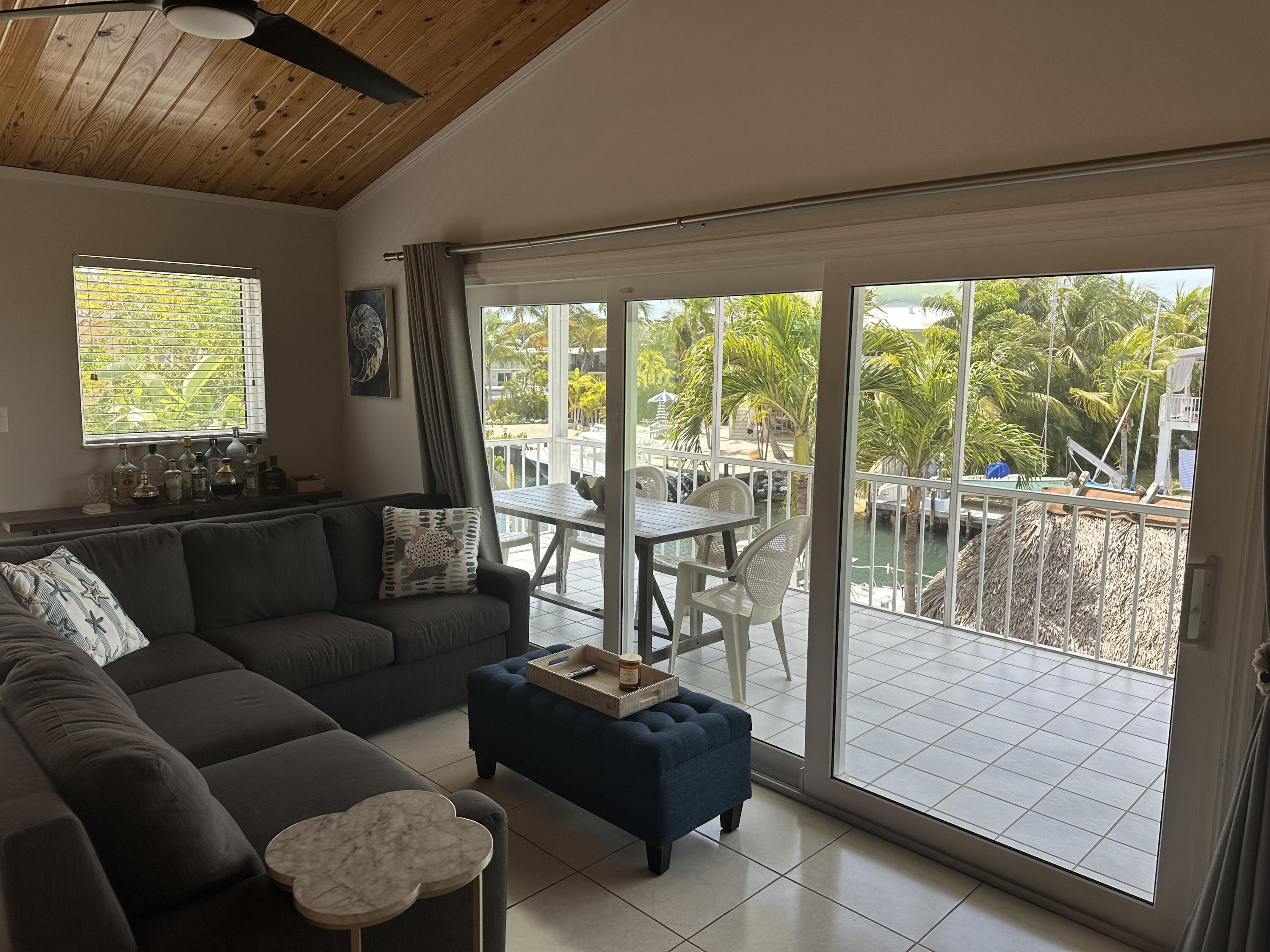 112 Captains Court Tavernier, FL 33070 - Photo 13 of 41 a living room with furniture and a floor to ceiling window