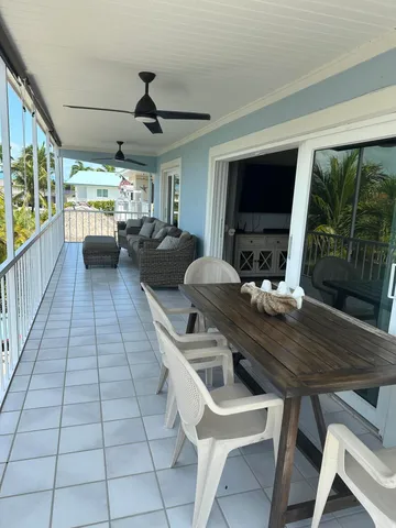 a view of a wooden table and chairs on the roof deck