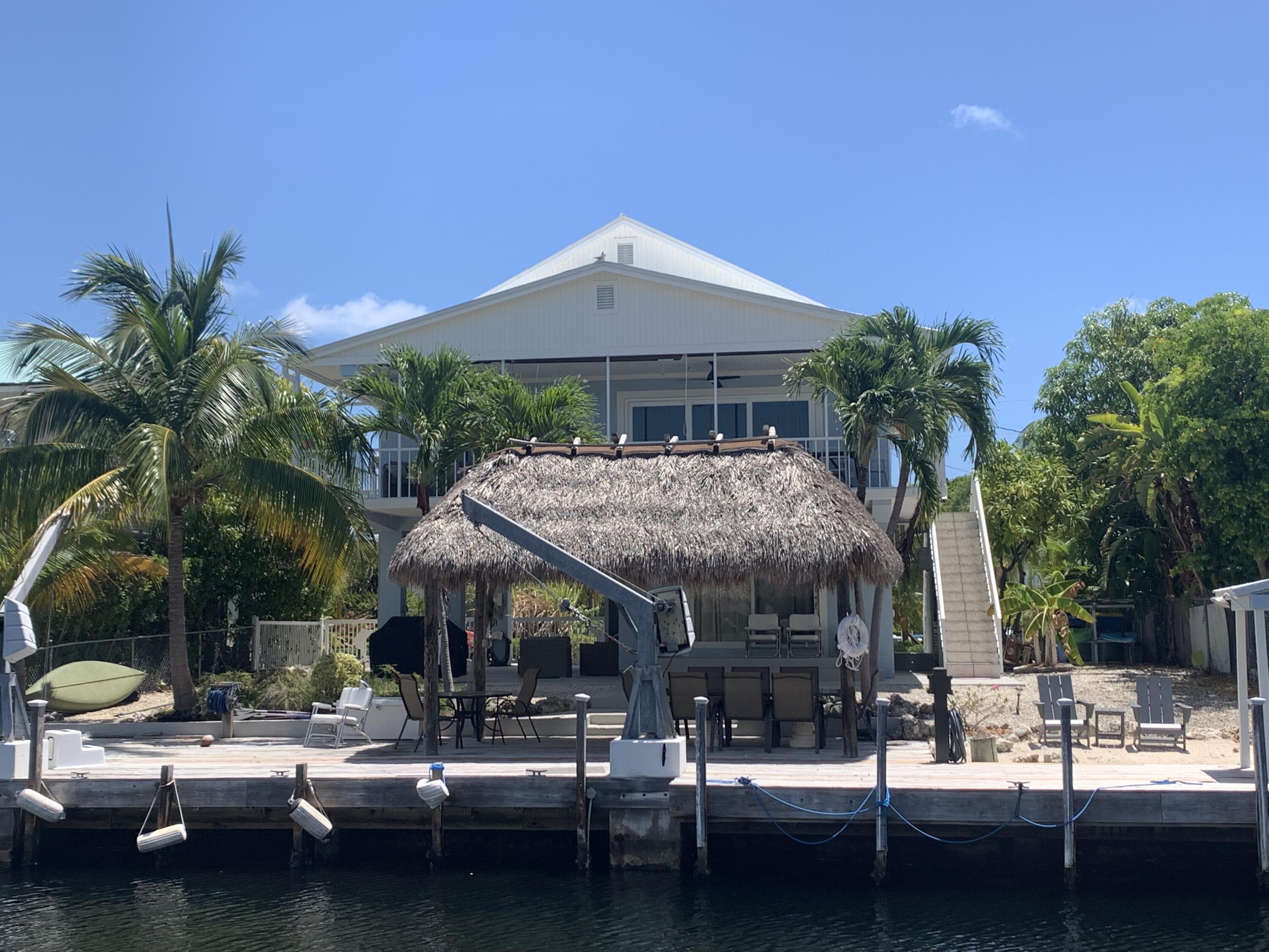 112 Captains Court Tavernier, FL 33070 - Photo 2 of 41 a view of a patio with swimming pool table and chairs