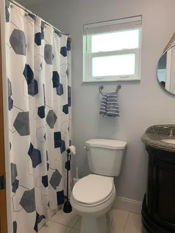 a bathroom with a shower and a toilet