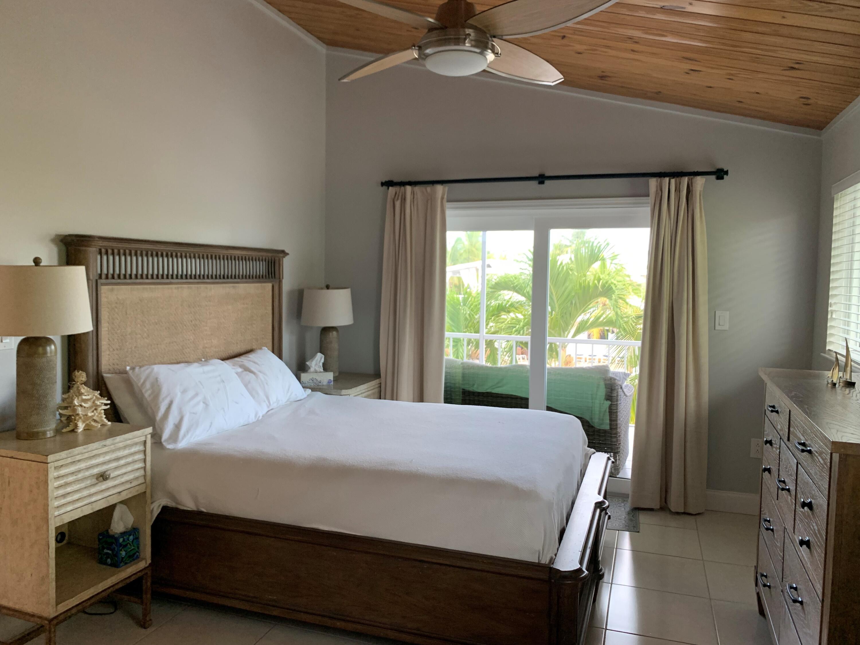 112 Captains Court Tavernier, FL 33070 - Photo 23 of 41 a bedroom with a bed and a window