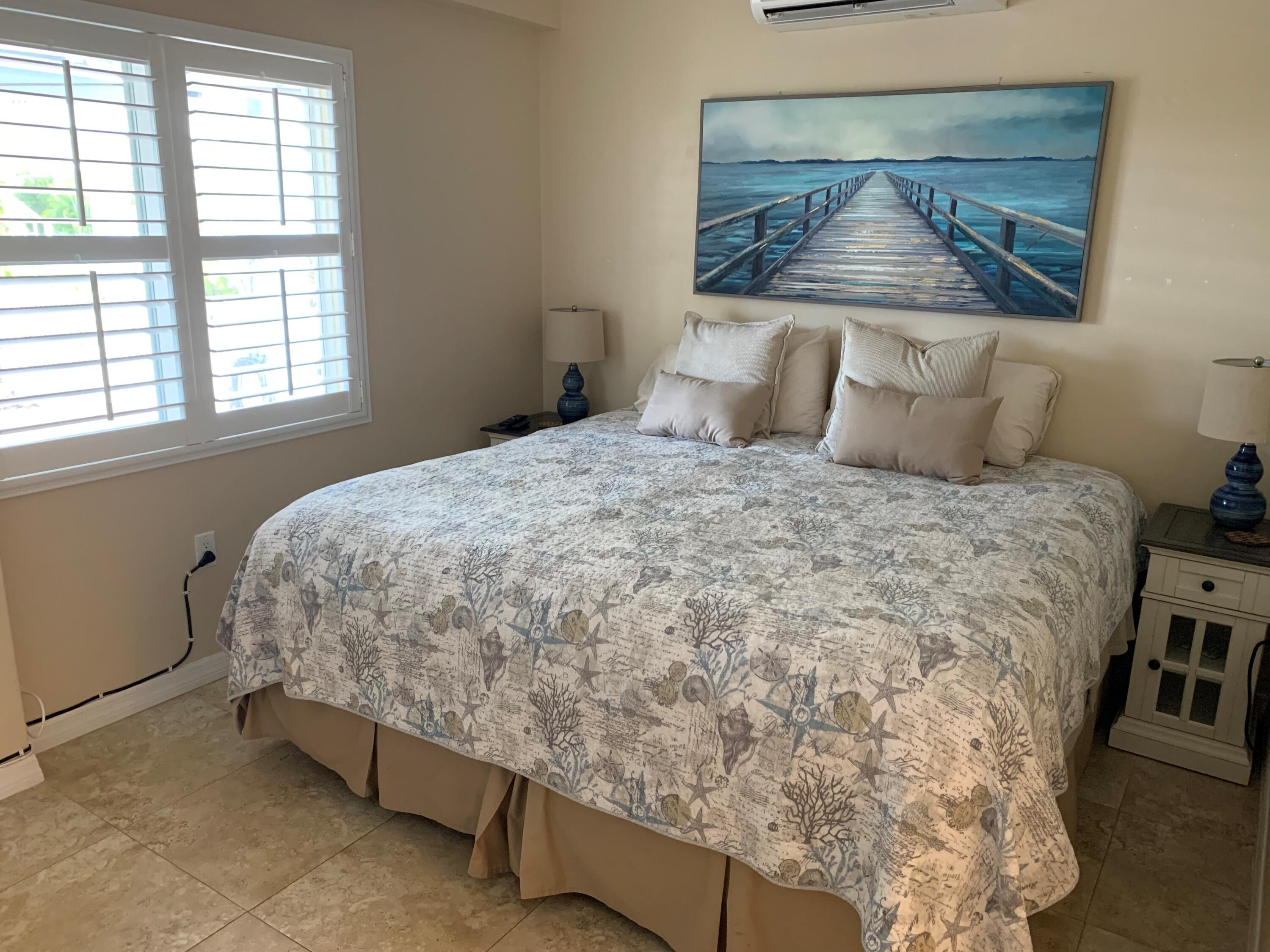 112 Captains Court Tavernier, FL 33070 - Photo 28 of 41 a bedroom with a bed and a window