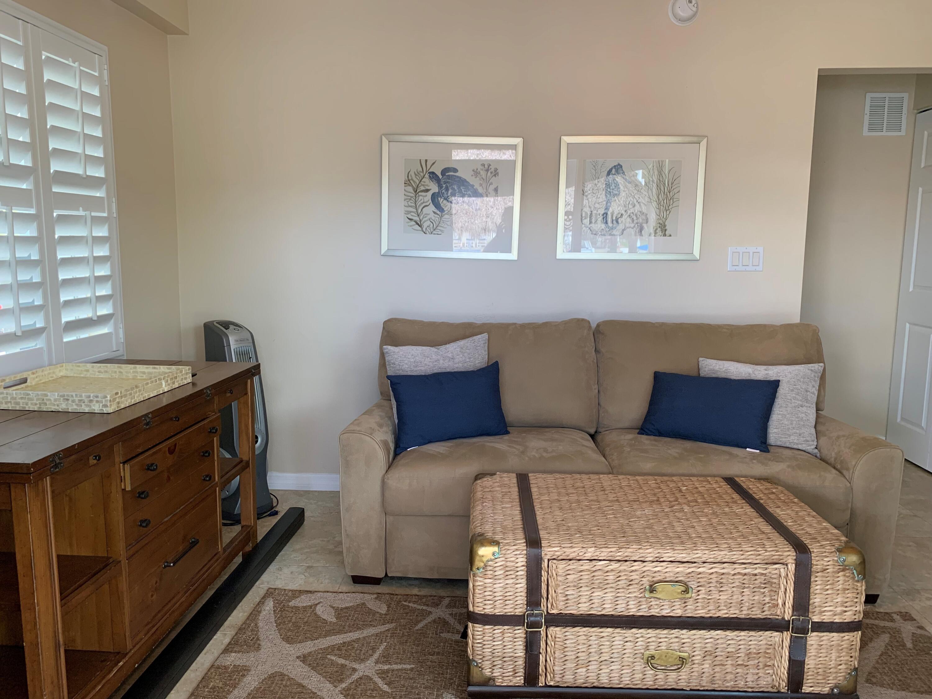 112 Captains Court Tavernier, FL 33070 - Photo 30 of 41 a bedroom with a bed and wooden floor