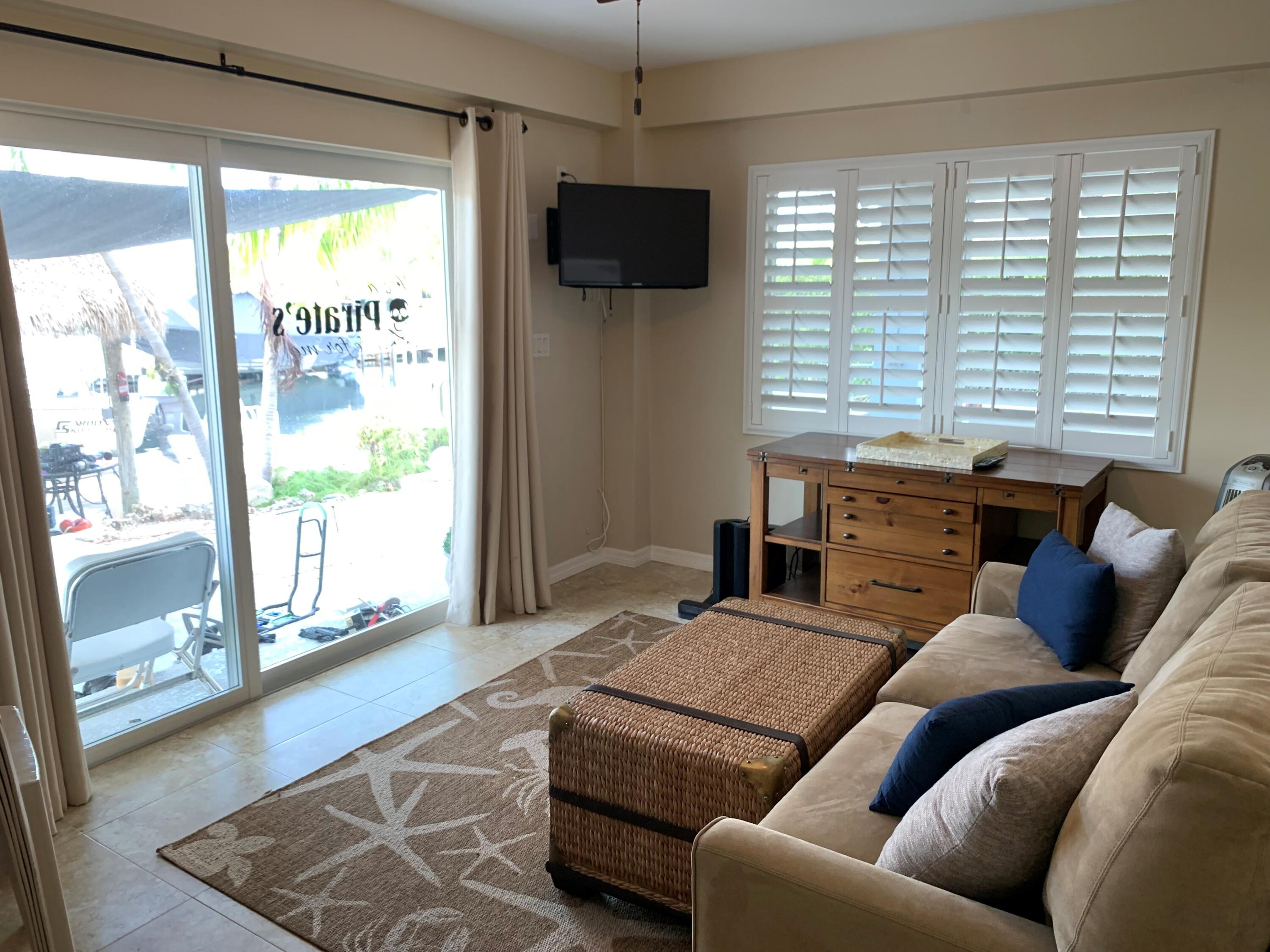 112 Captains Court Tavernier, FL 33070 - Photo 31 of 41 a living room with furniture and a flat screen tv