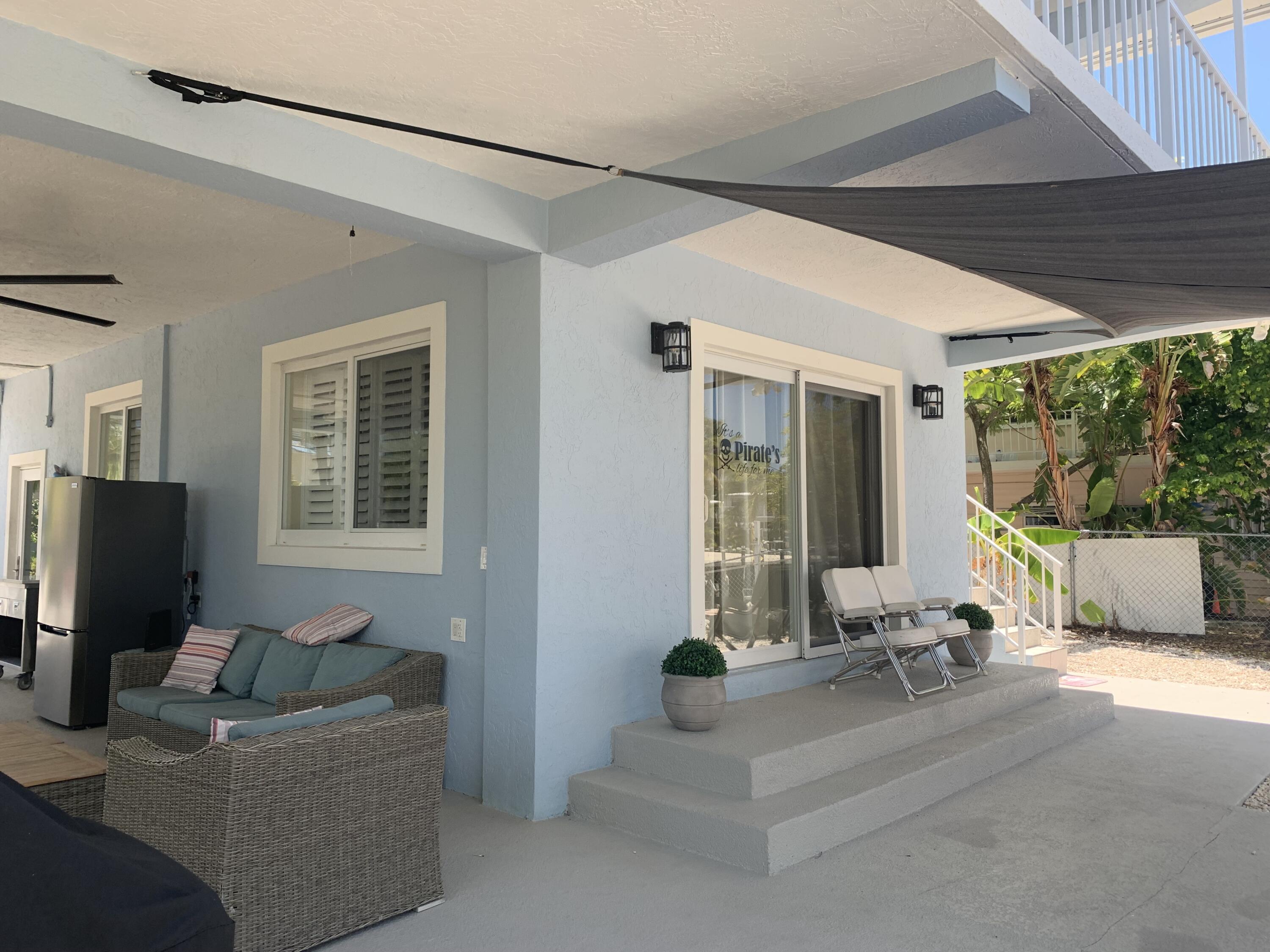 112 Captains Court Tavernier, FL 33070 - Photo 32 of 41 a living room with furniture and a floor to ceiling window