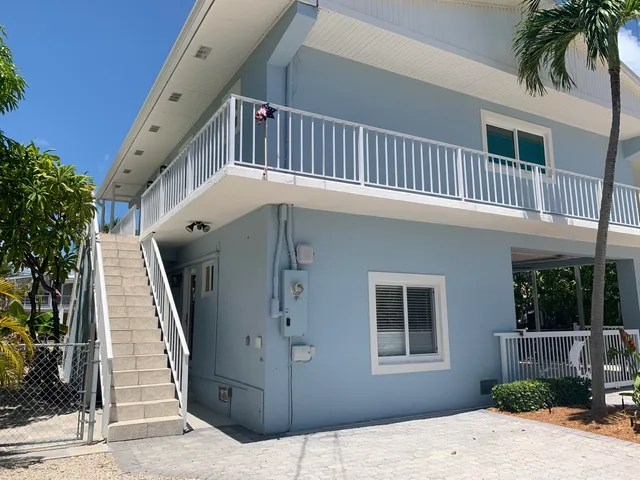 a front view of a house with a yard and a garage