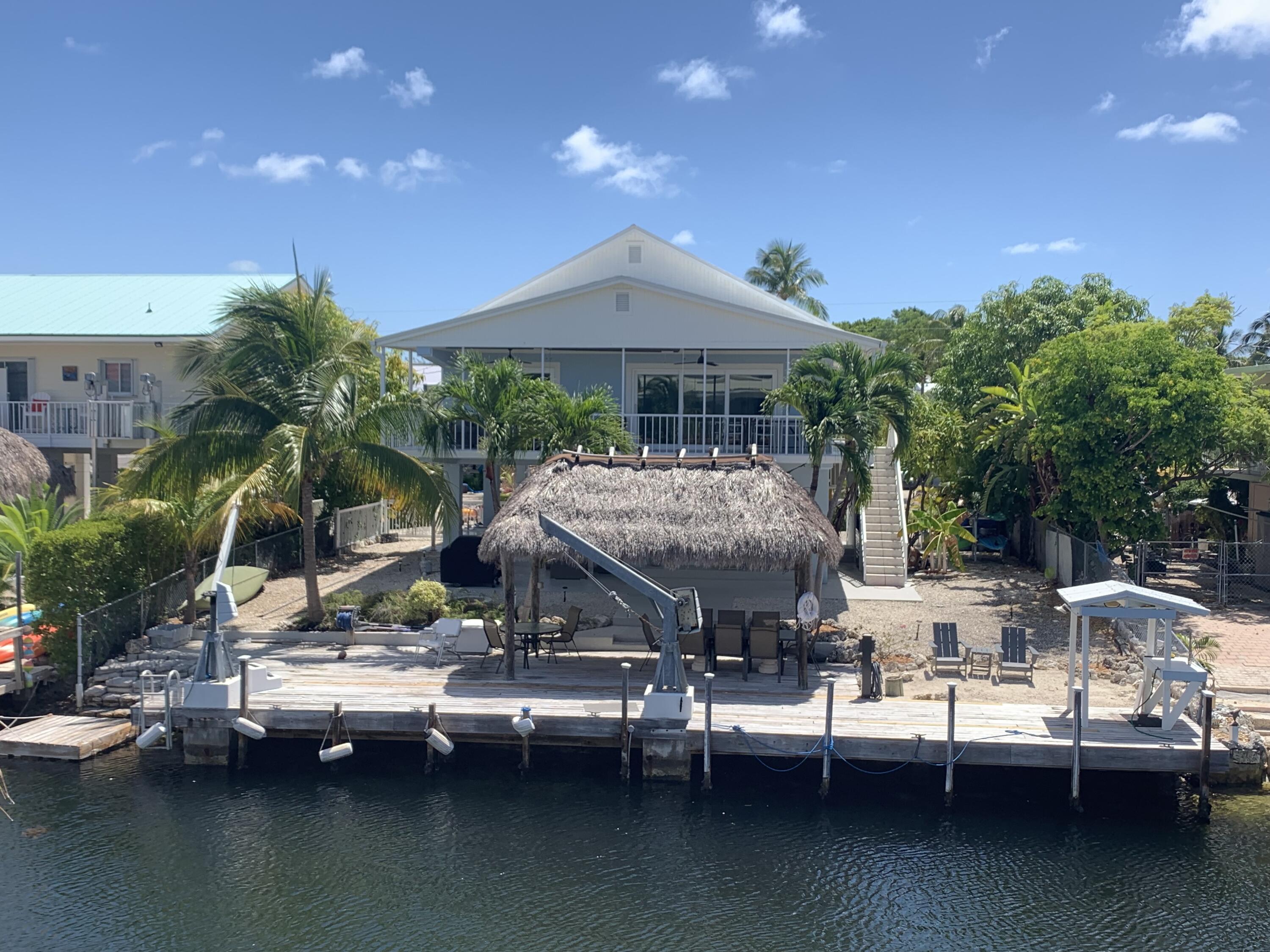 112 Captains Court Tavernier, FL 33070 - Photo 41 of 41 a view of house with lake view and a garden