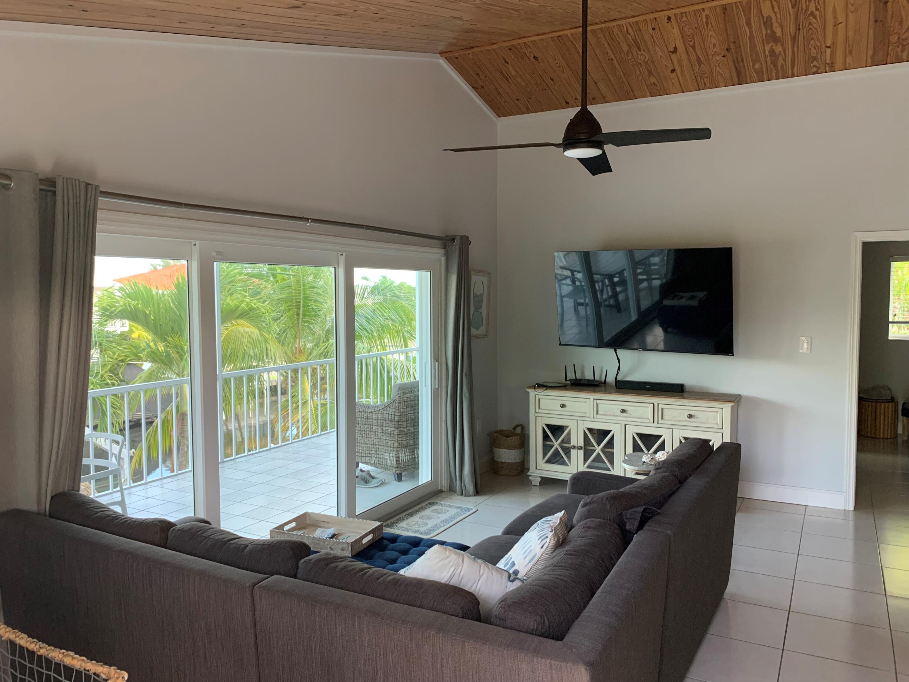 112 Captains Court Tavernier, FL 33070 - Photo 5 of 41 a living room with furniture and a flat screen tv