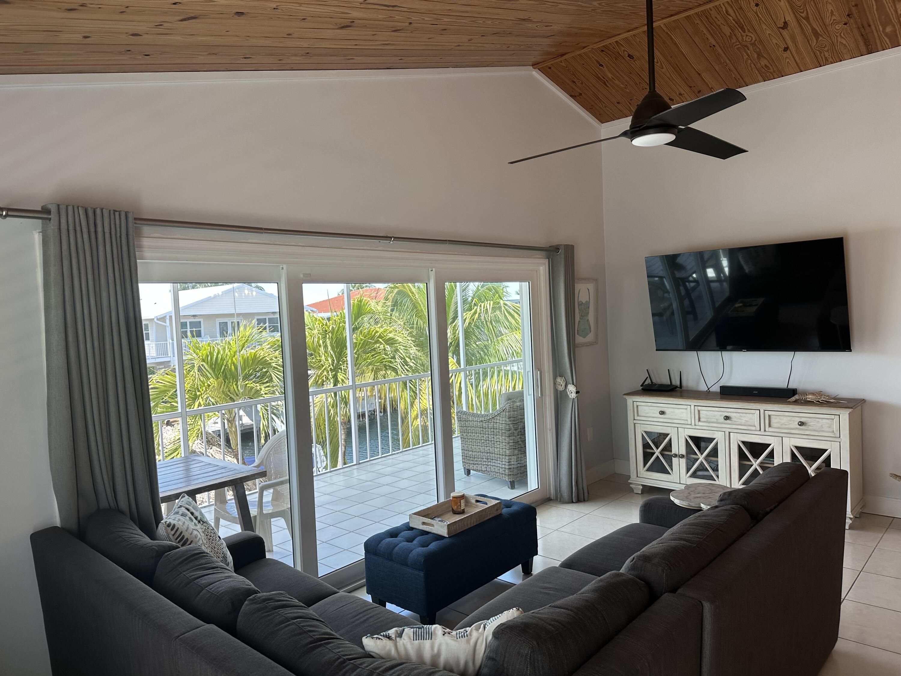 112 Captains Court Tavernier, FL 33070 - Photo 6 of 41 a living room with furniture and a flat screen tv