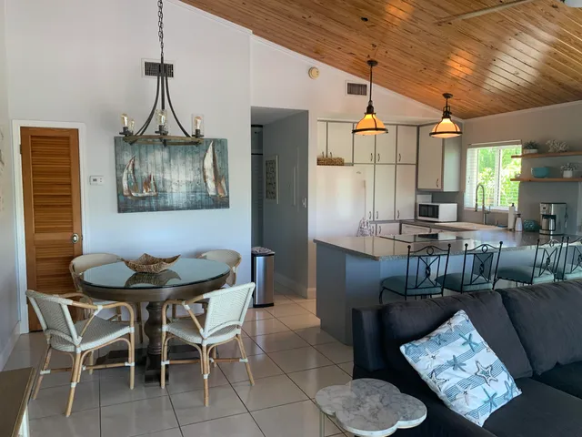 a kitchen with granite countertop a stove a sink and a microwave