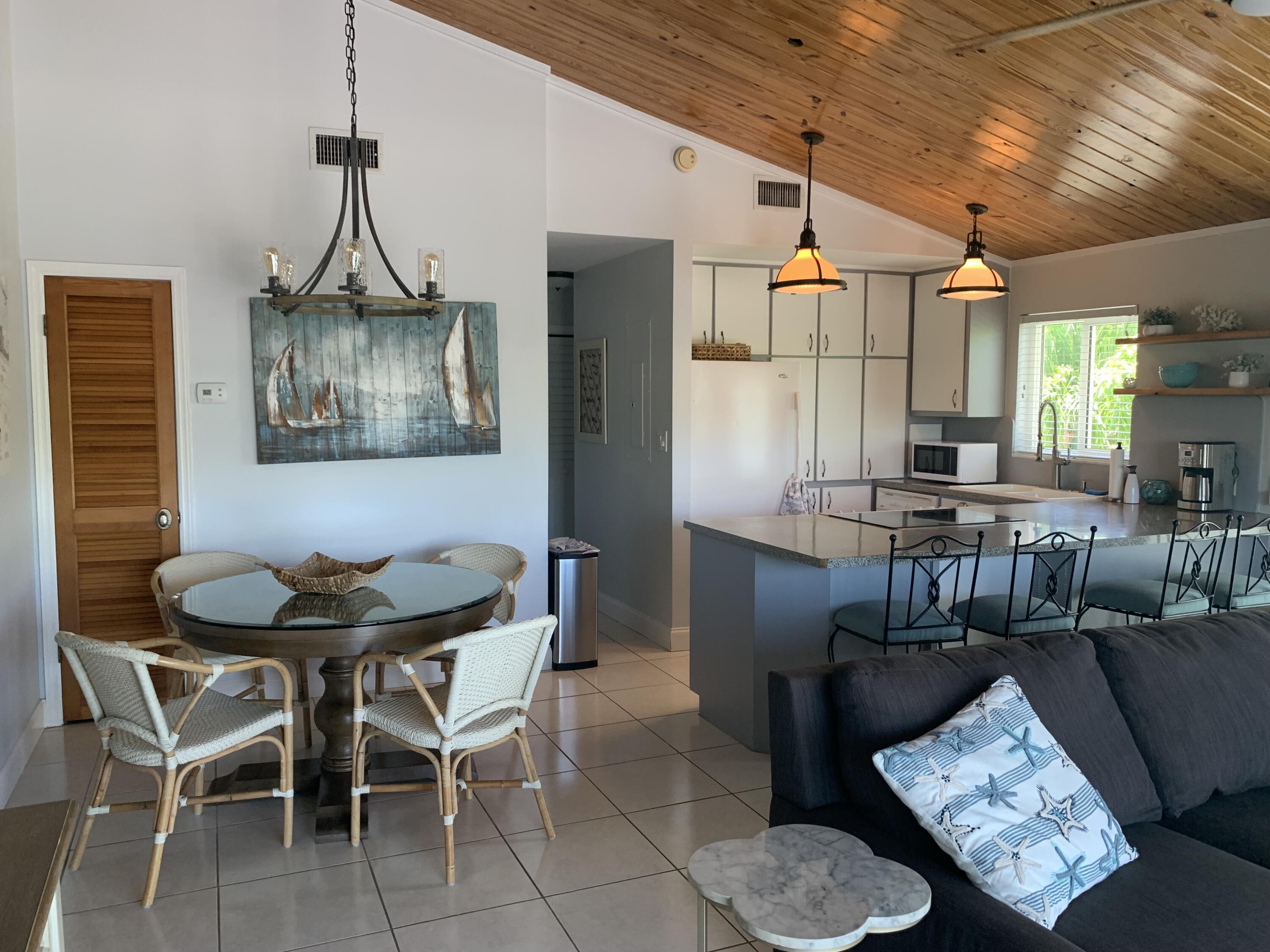 112 Captains Court Tavernier, FL 33070 - Photo 8 of 41 a dining room with furniture and window
