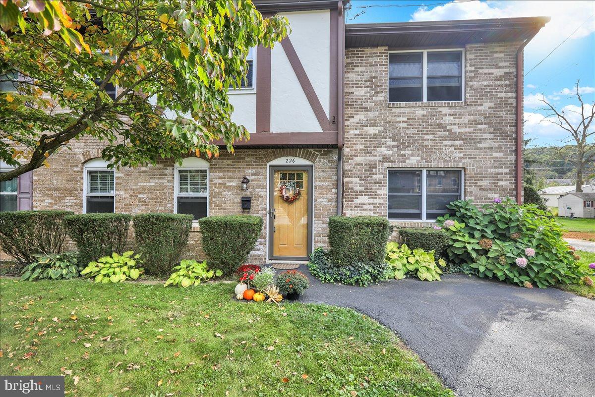 226 West Ruth Avenue Robesonia, PA 19551 - Photo 1 of 32 Charming brick facade with lush greenery.