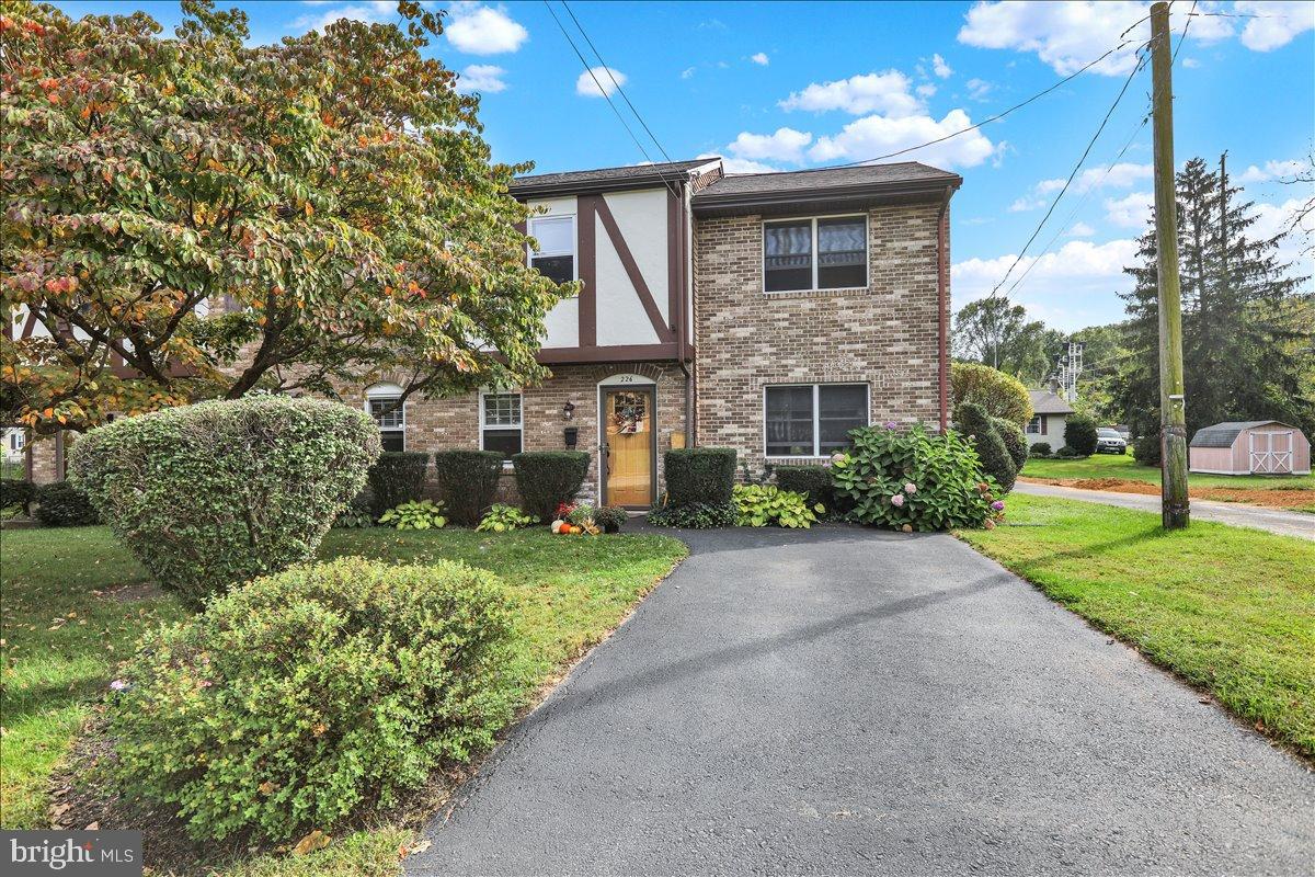 226 West Ruth Avenue Robesonia, PA 19551 - Photo 29 of 32 Charming brick facade with lush landscaping.