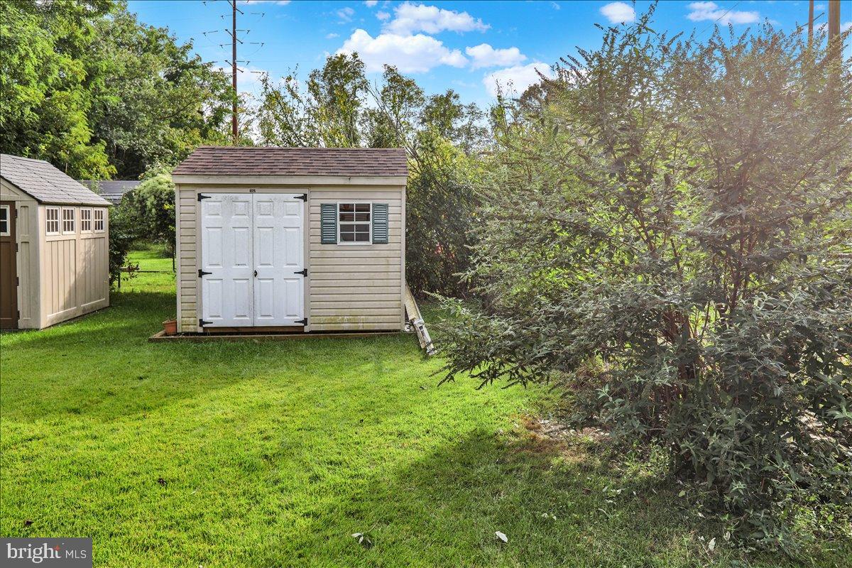 226 West Ruth Avenue Robesonia, PA 19551 - Photo 30 of 32 Charming garden shed nestled in lush greenery.